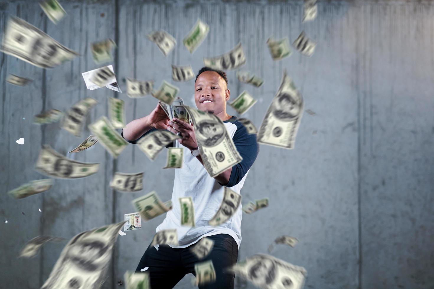 black businessman making the rain of money photo