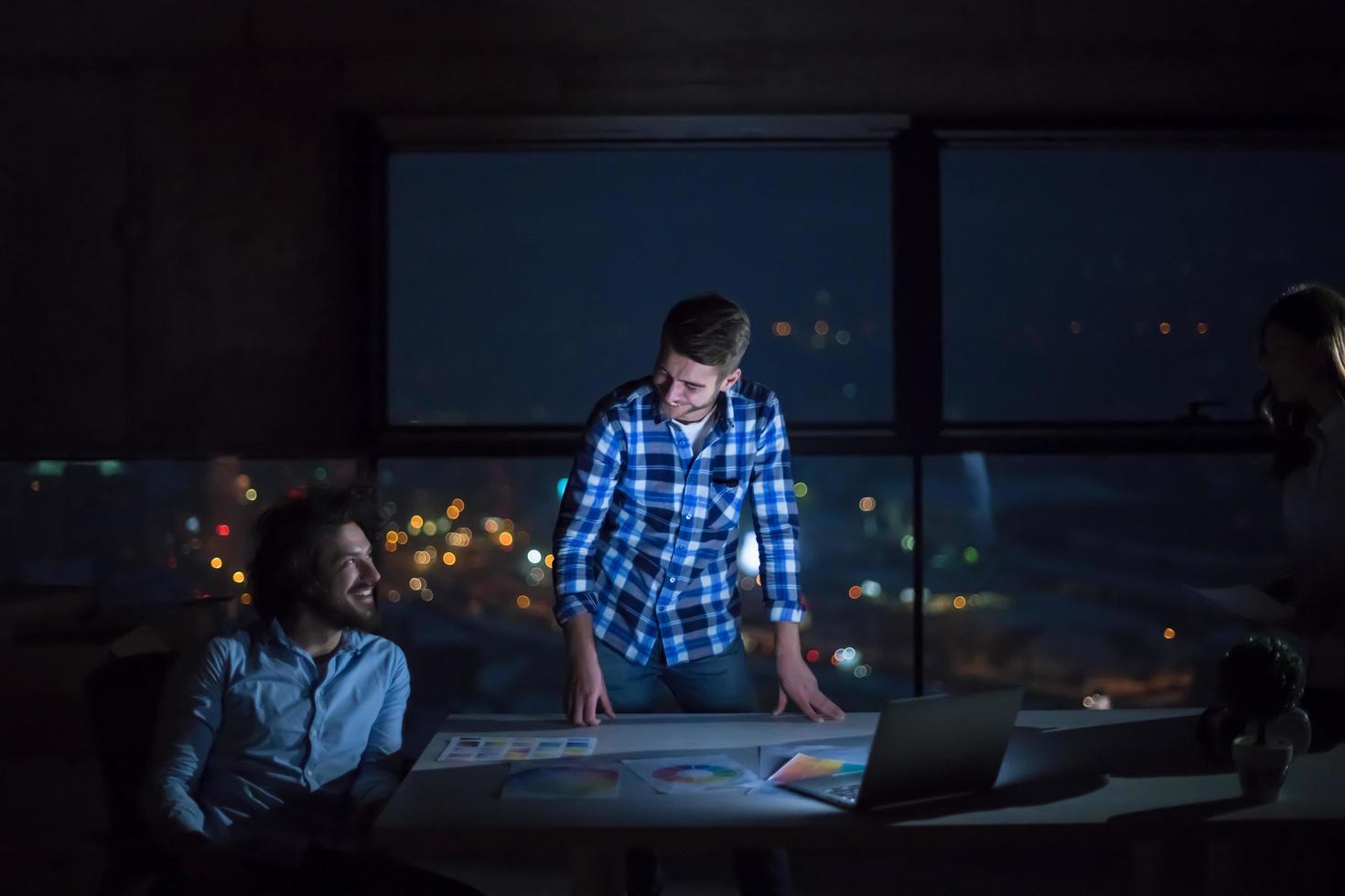 business people on construction site  in new startup office at night photo