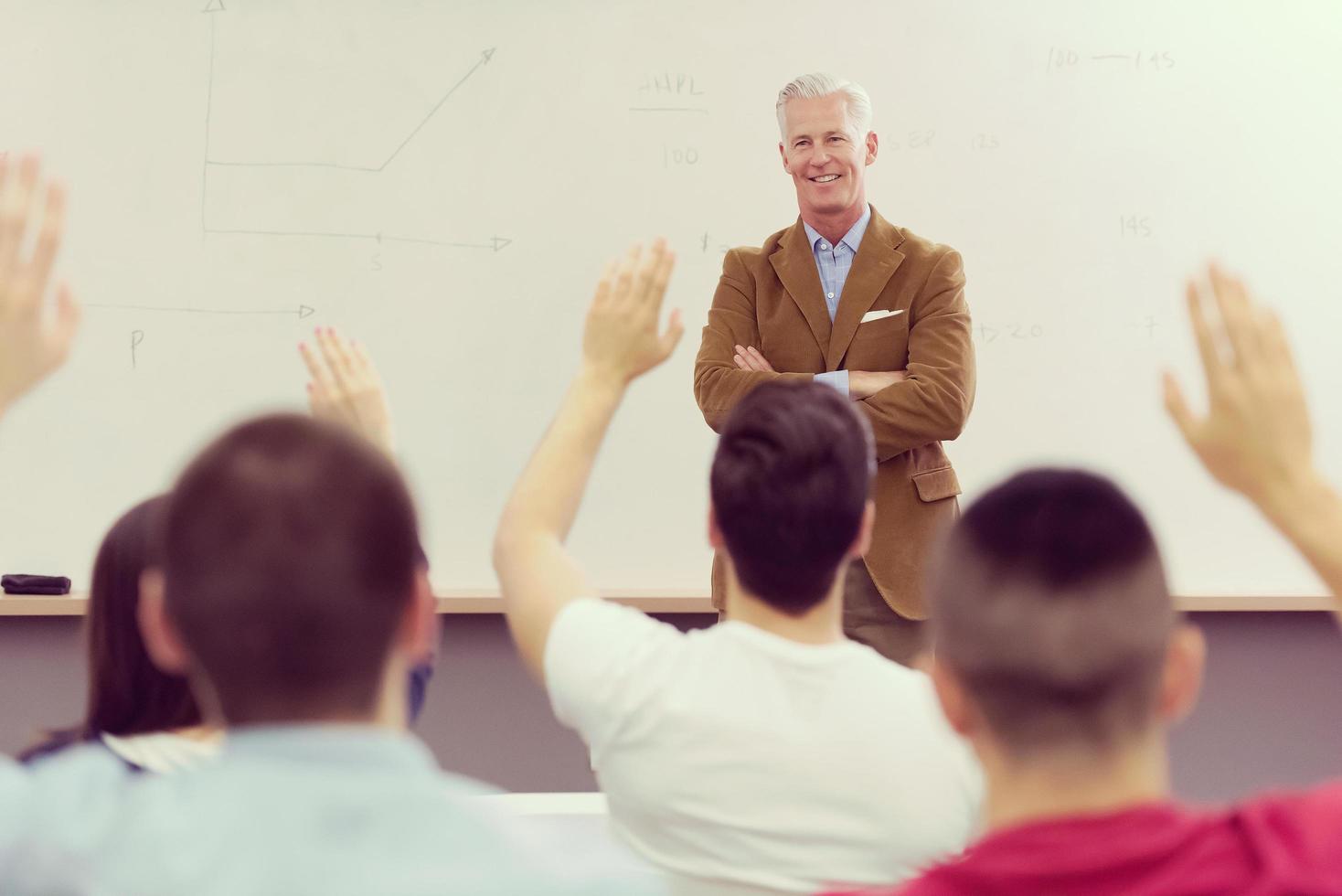 teacher with a group of students in classroom photo