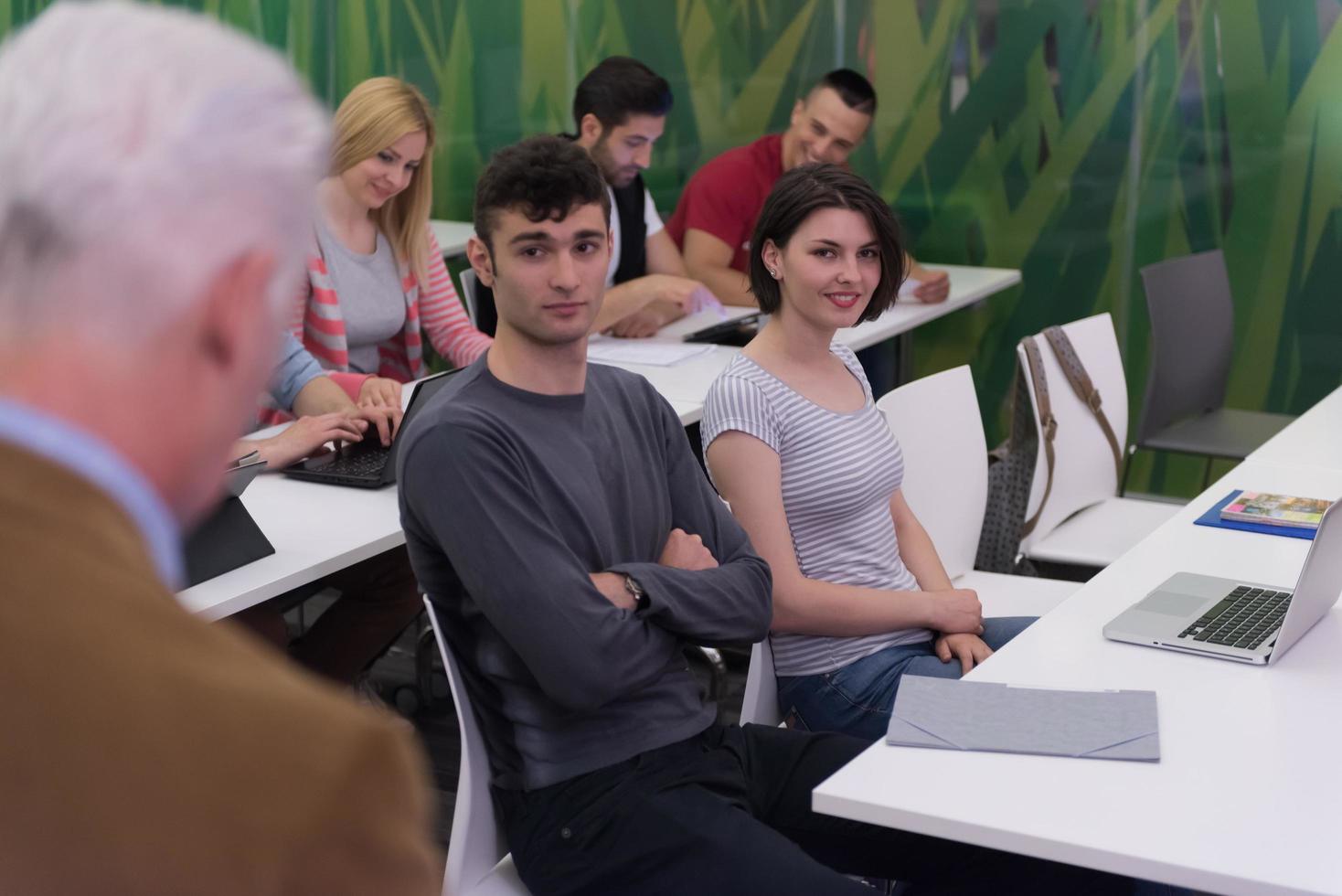teacher with a group of students in classroom photo