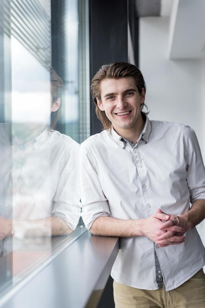 young businessman in startup office by the window photo