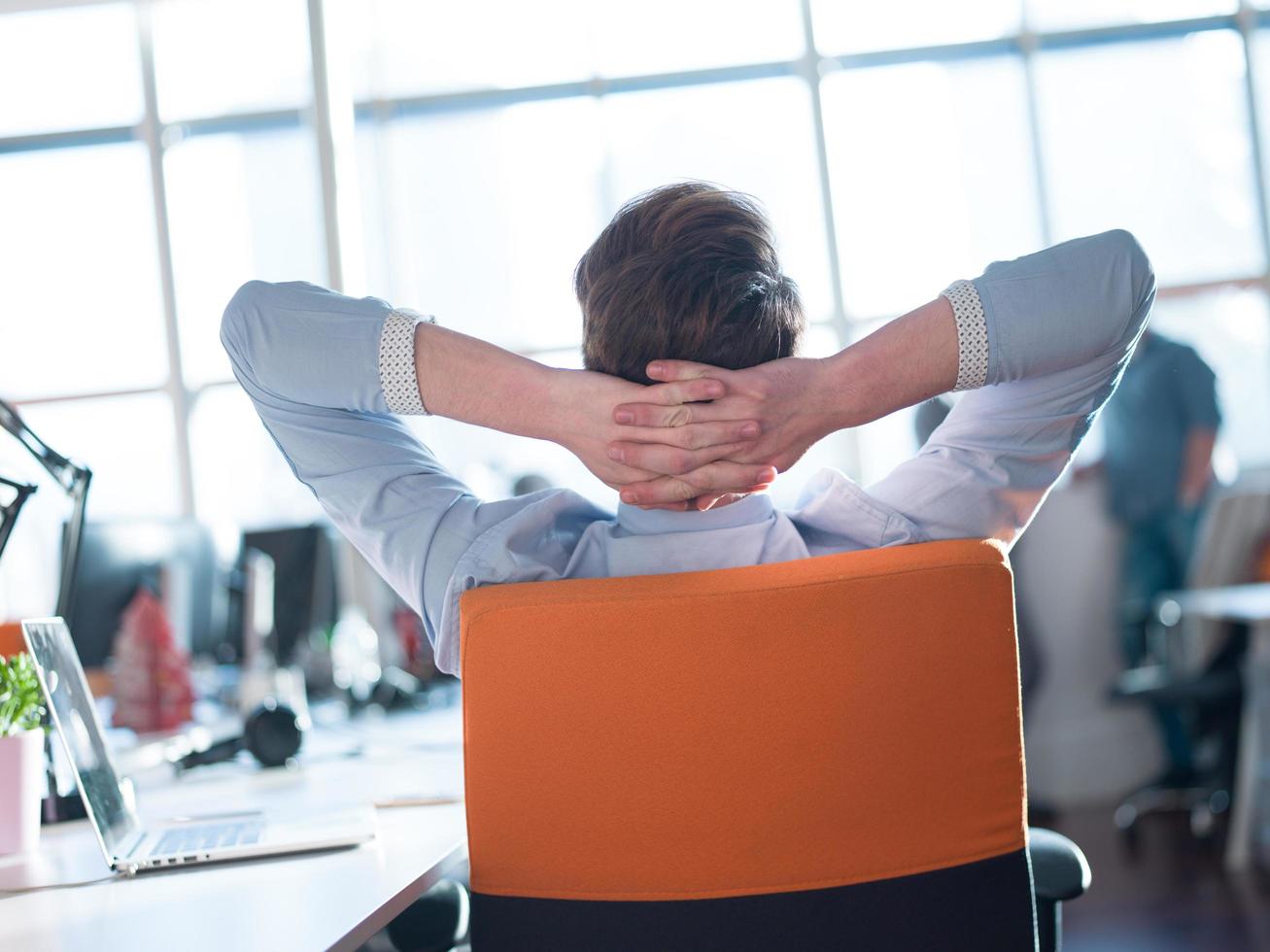 young businessman relaxing at the desk photo