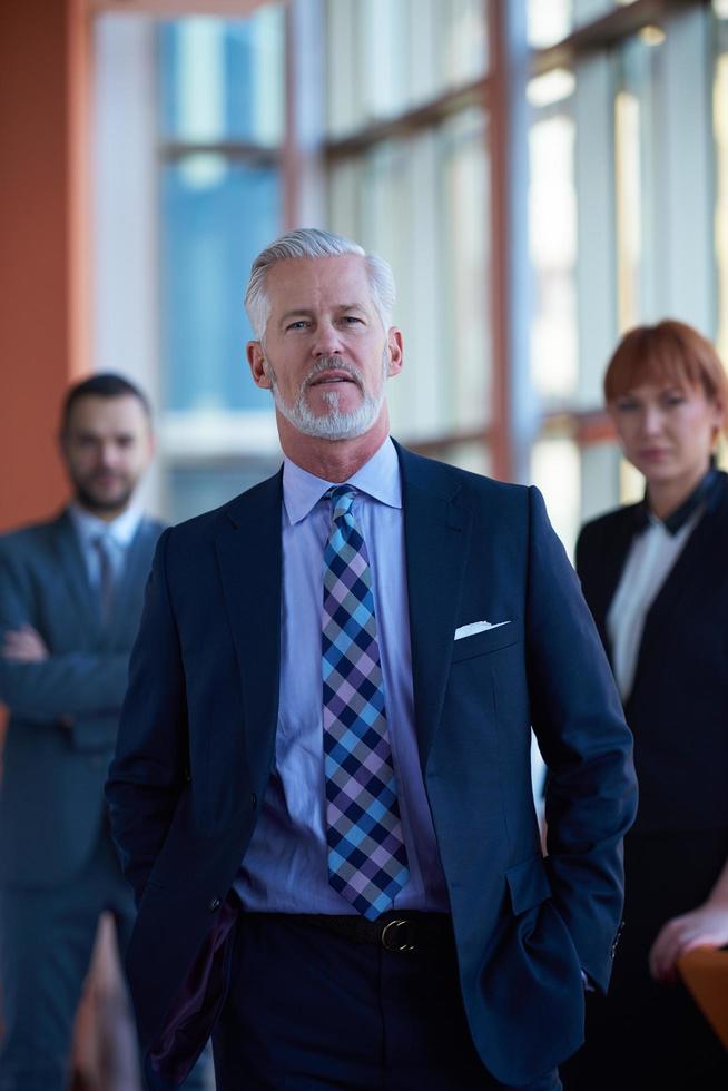 senior business man with his team at office photo