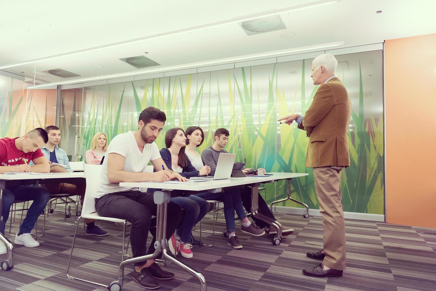 teacher with a group of students in classroom photo