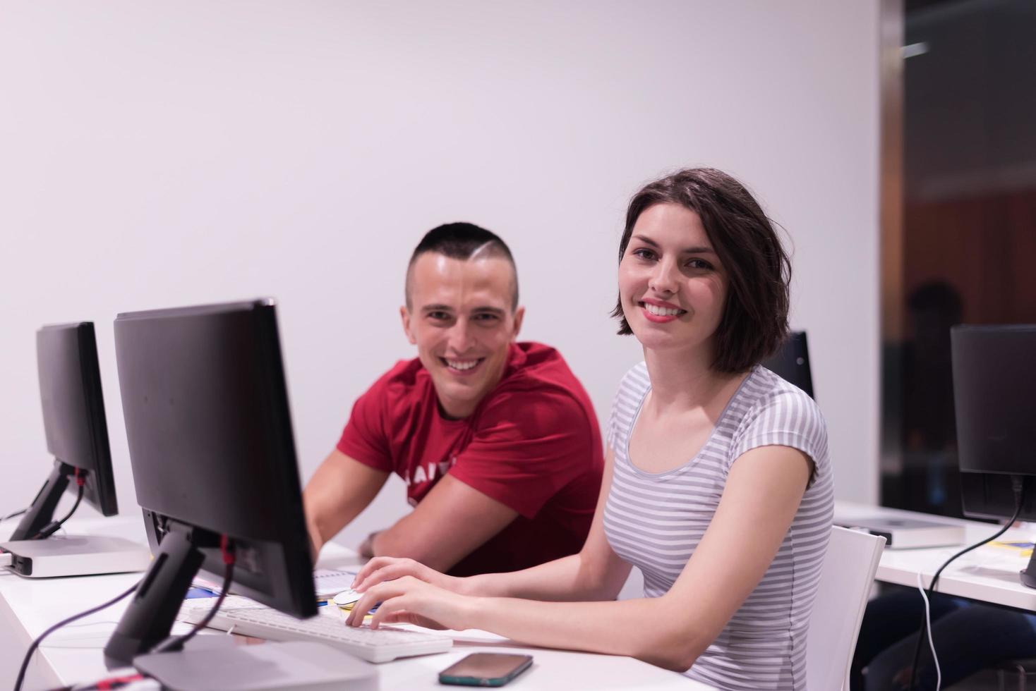 technology students group working  in computer lab school  classroom photo