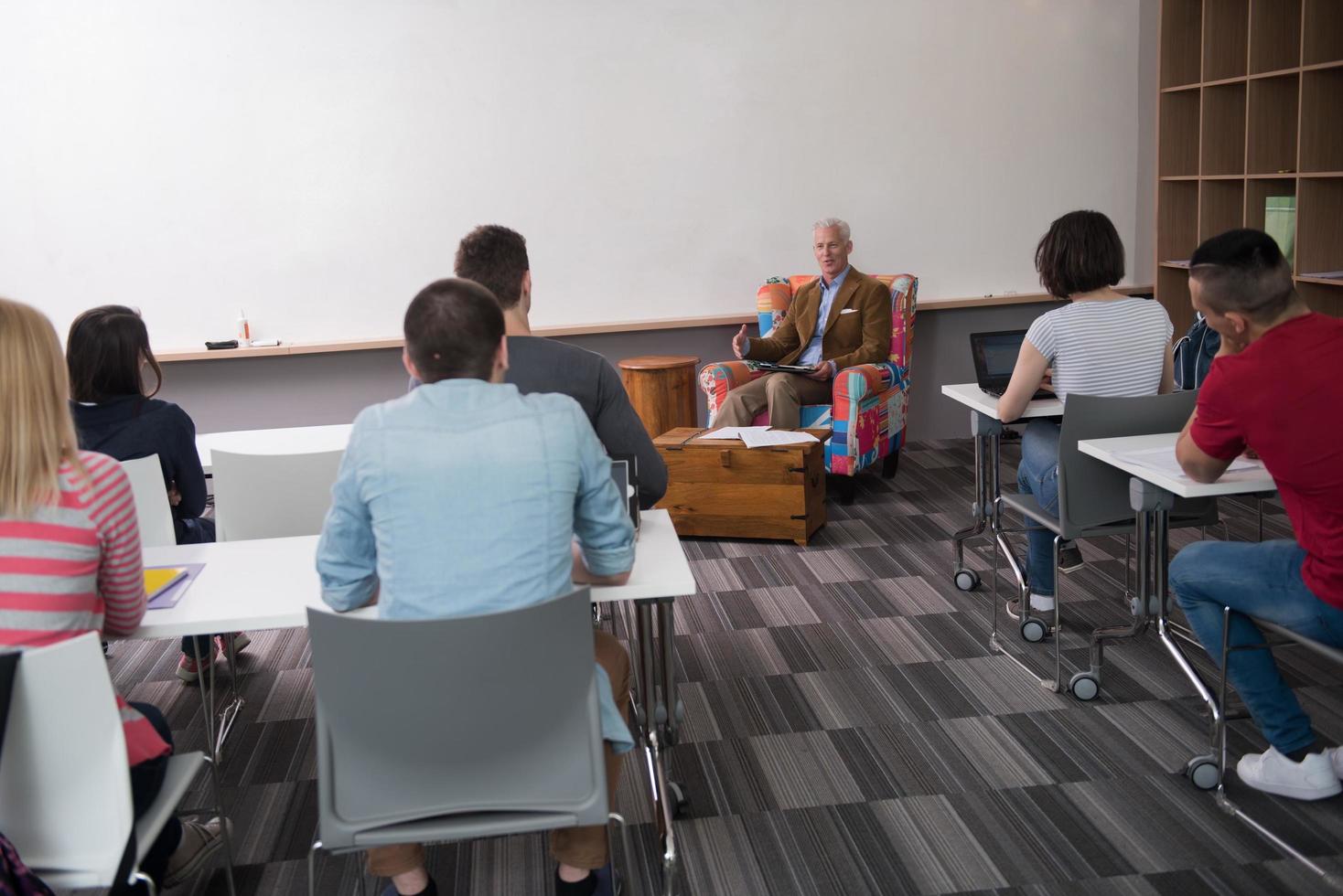 teacher with a group of students in classroom photo