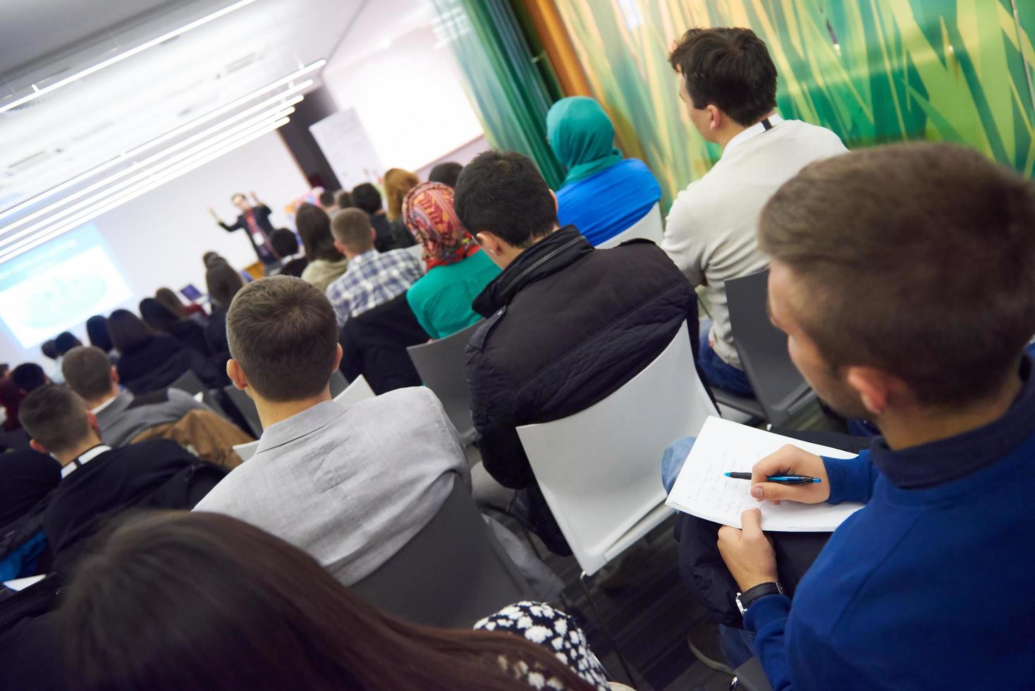 taking notes on business conference photo