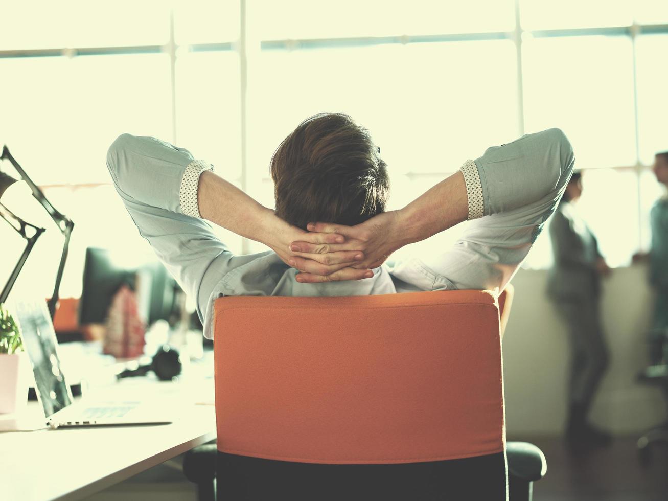 young businessman relaxing at the desk photo