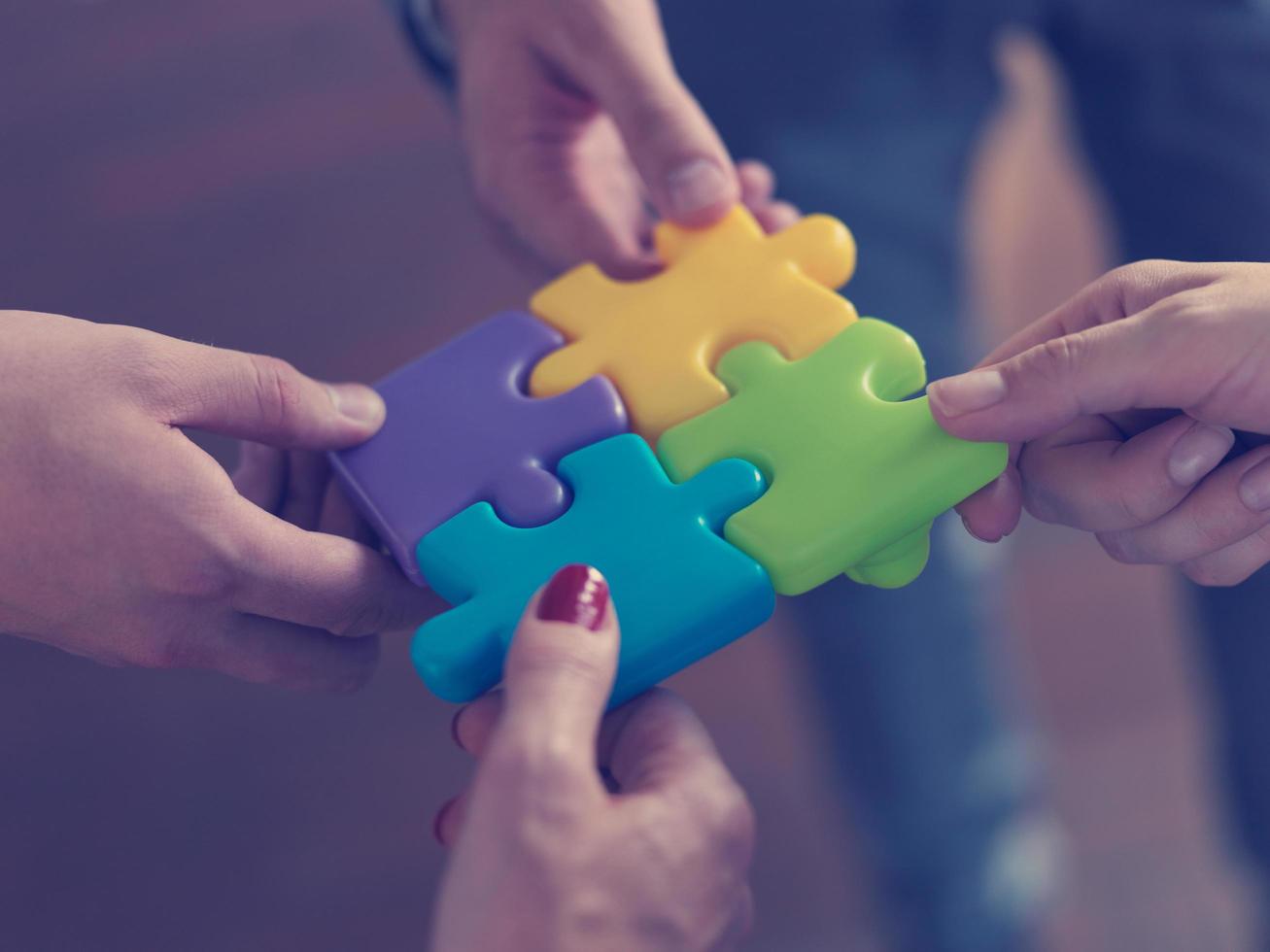 business people group assembling jigsaw puzzle photo