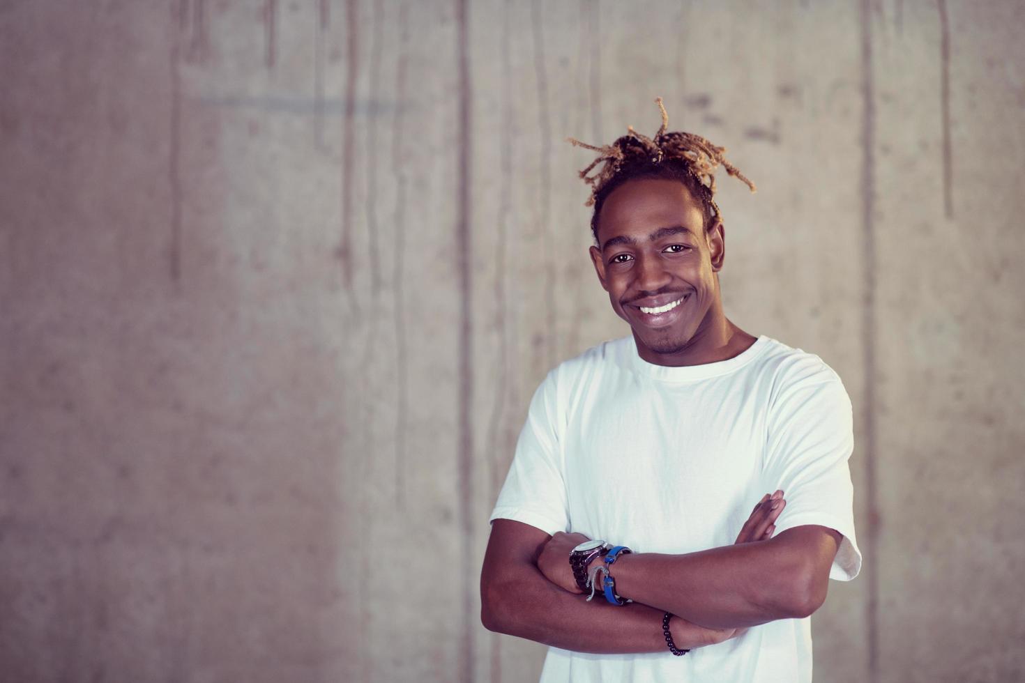 portrait of black businessman in front of a concrete wall photo