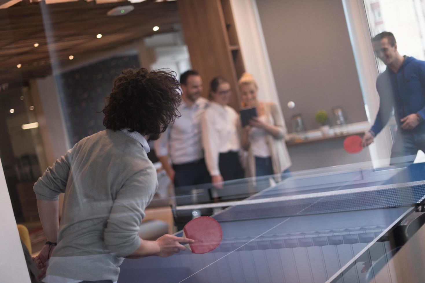 startup business team playing ping pong tennis photo