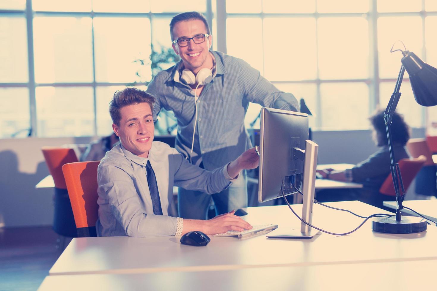 Two Business People Working With computer in office photo