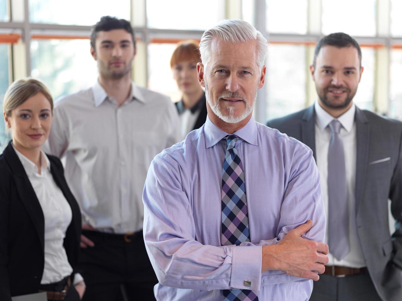 senior business man with his team at office photo