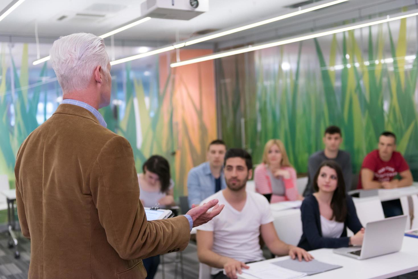teacher with a group of students in classroom photo