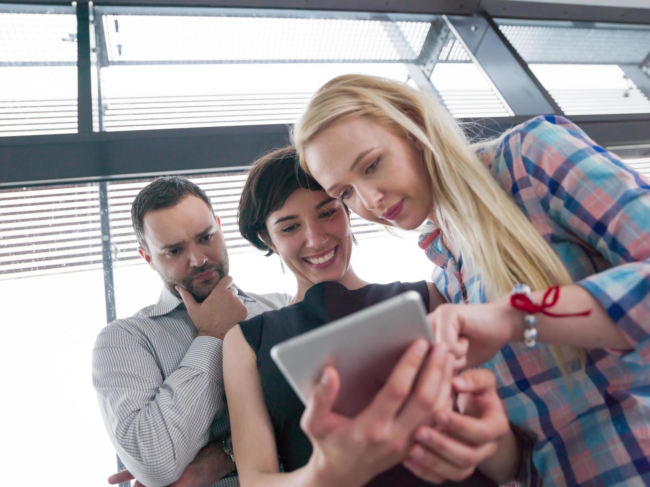 group of Business People Working With Tablet in startup office photo