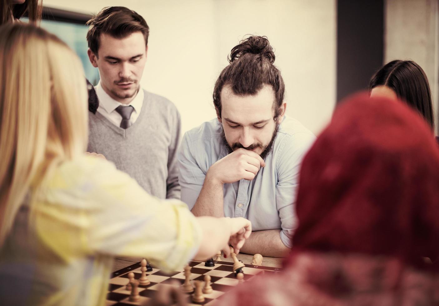 multiethnic group of business people playing chess photo