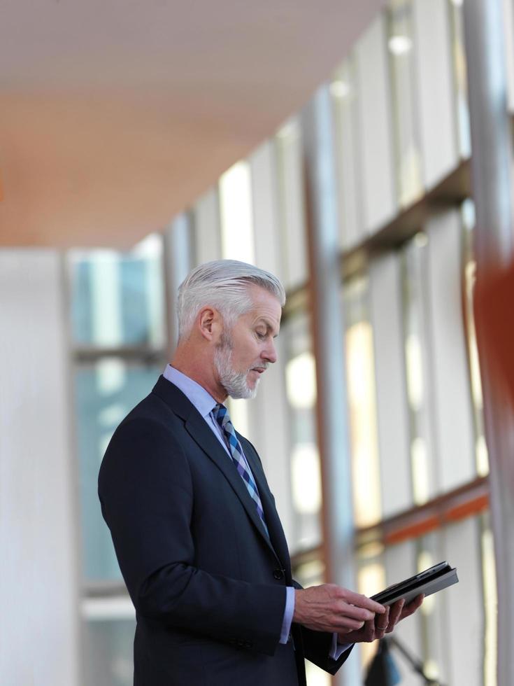 senior business man working on tablet computer photo