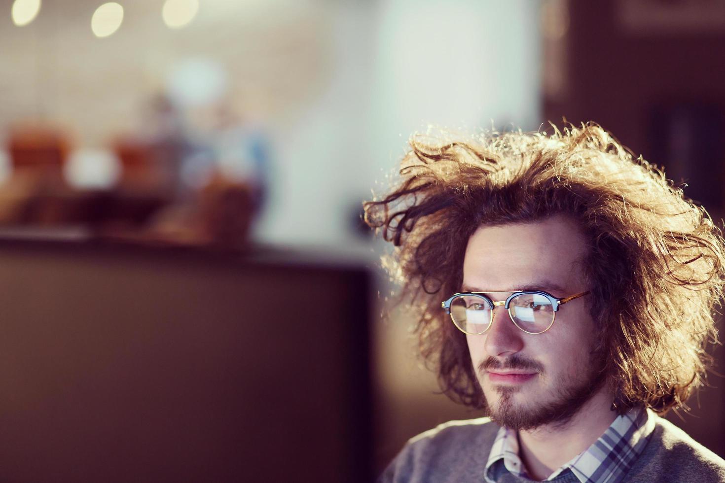 man working on computer in dark office photo