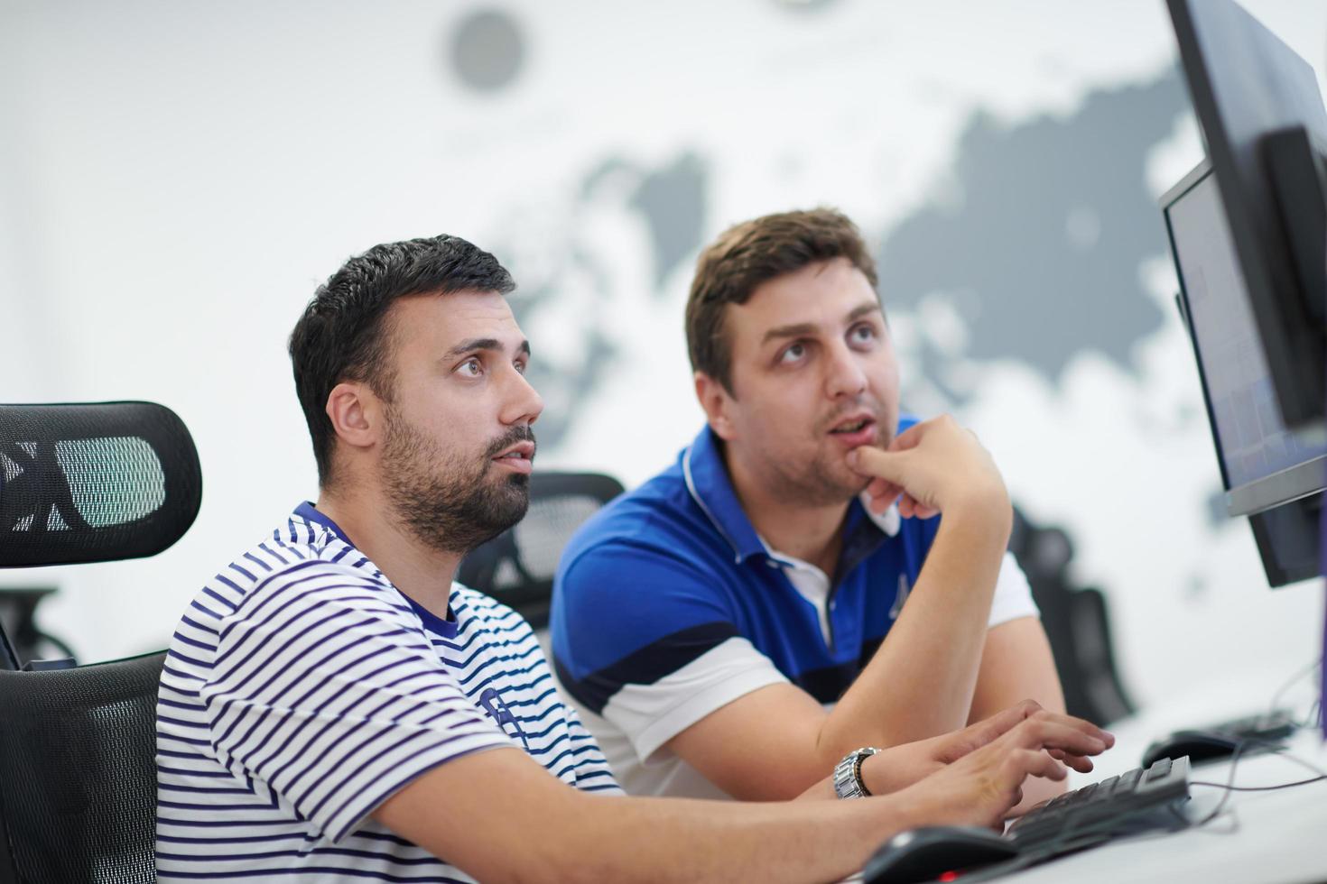 two male software developers working on computer photo