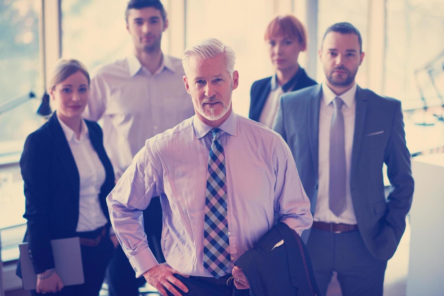 senior business man with his team at office photo