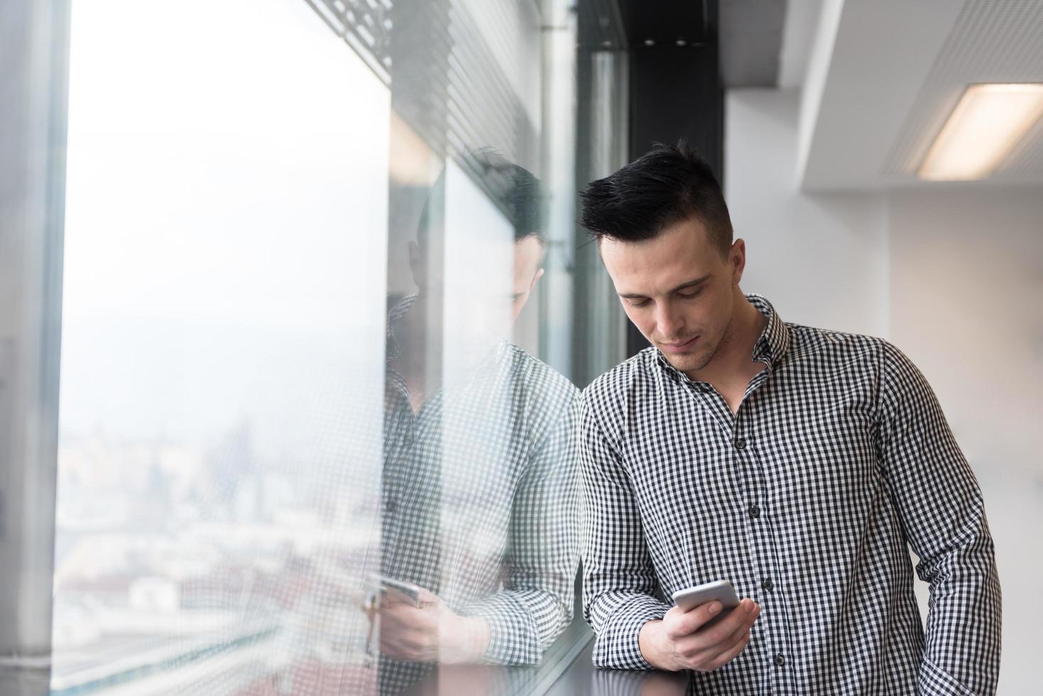 young business man using smart phone at office photo
