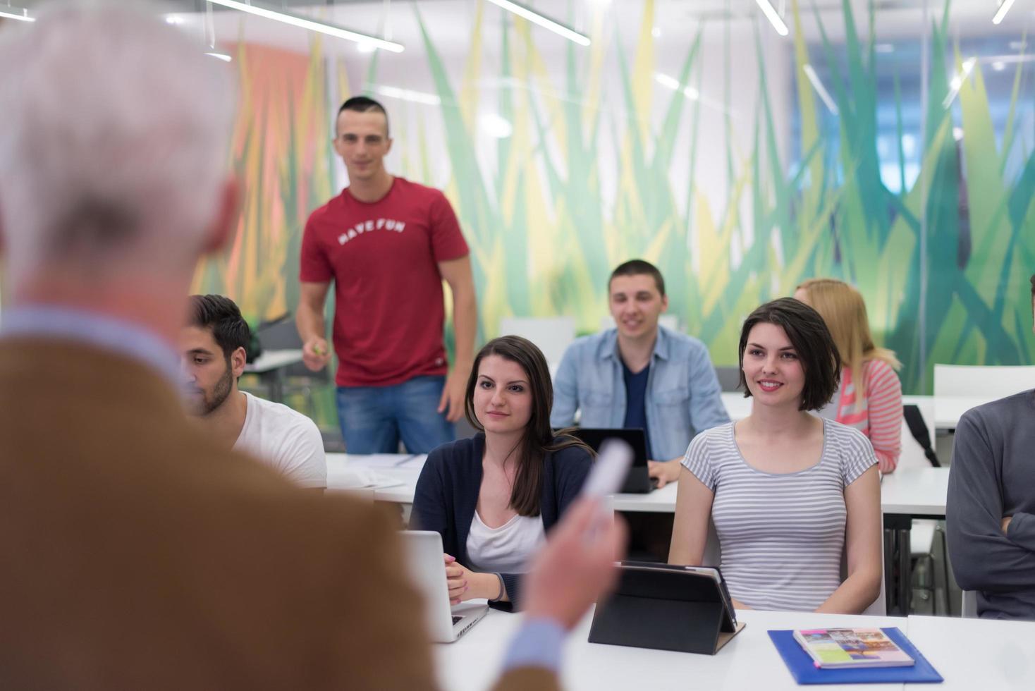 teacher with a group of students in classroom photo
