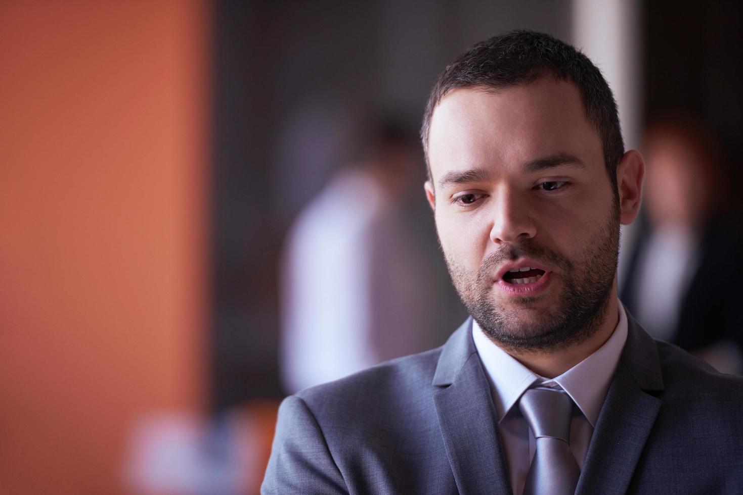 young business man portrait  at modern office photo