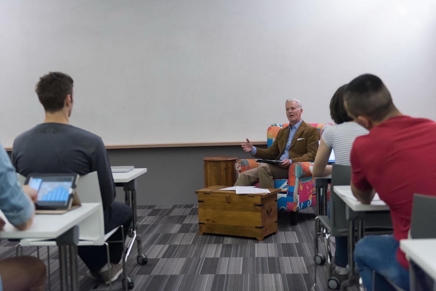 teacher with a group of students in classroom photo