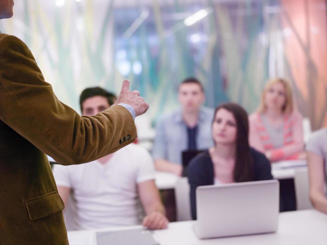close up of teacher hand while teaching and explaining  lessons to studenst  in classroom photo