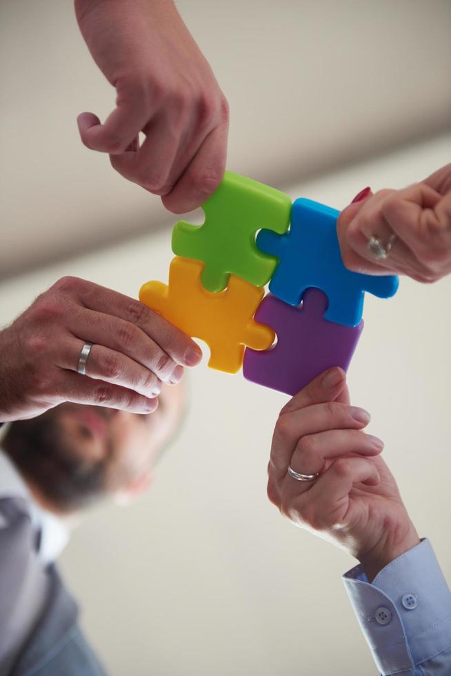 business people group assembling jigsaw puzzle photo