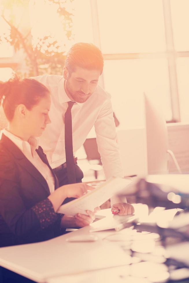business couple working together on project, sunrise in background photo