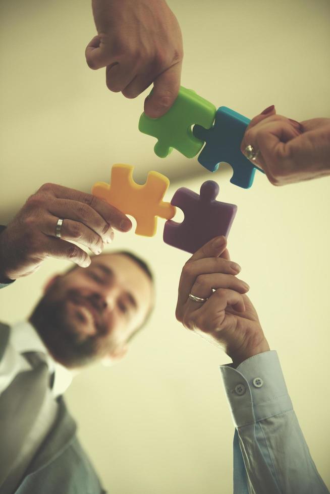 business people group assembling jigsaw puzzle photo