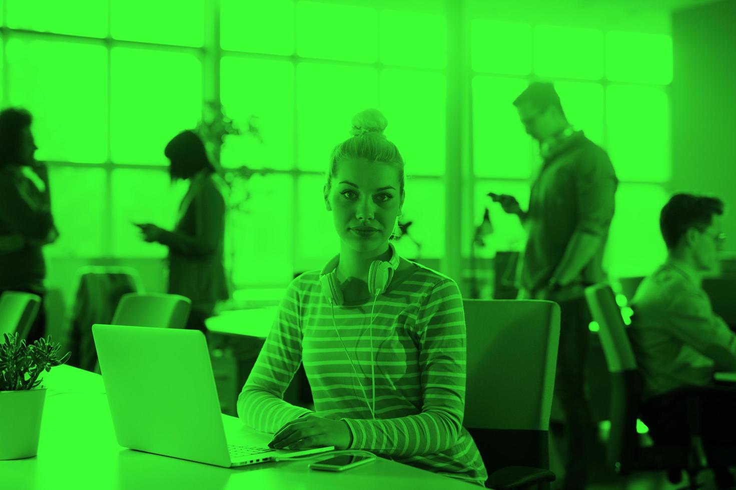 businesswoman using a laptop in startup office photo
