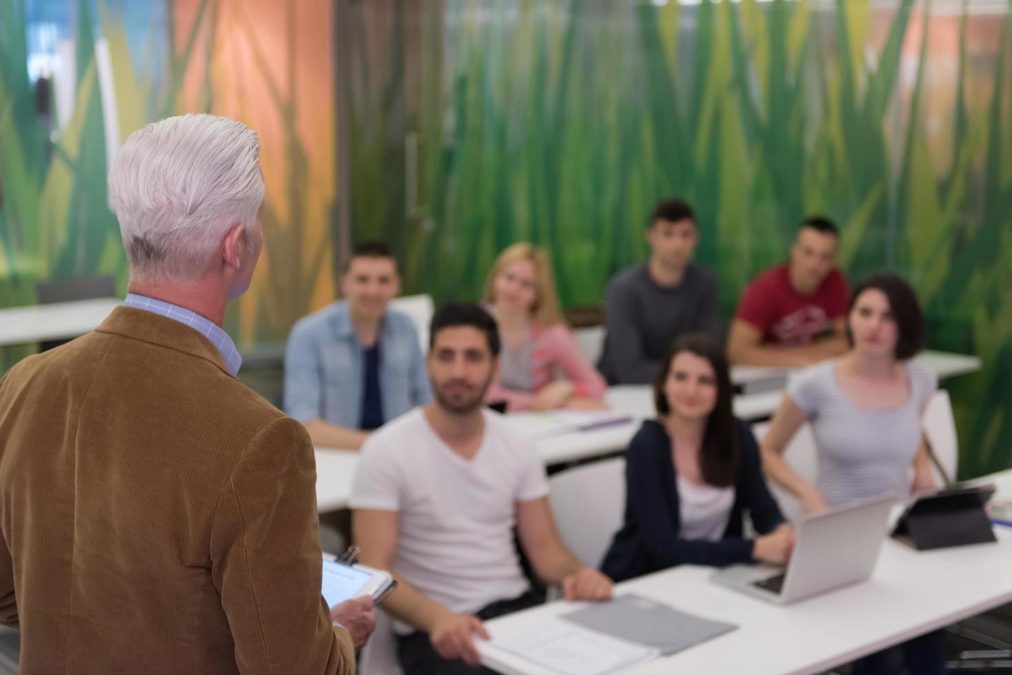 teacher with a group of students in classroom photo