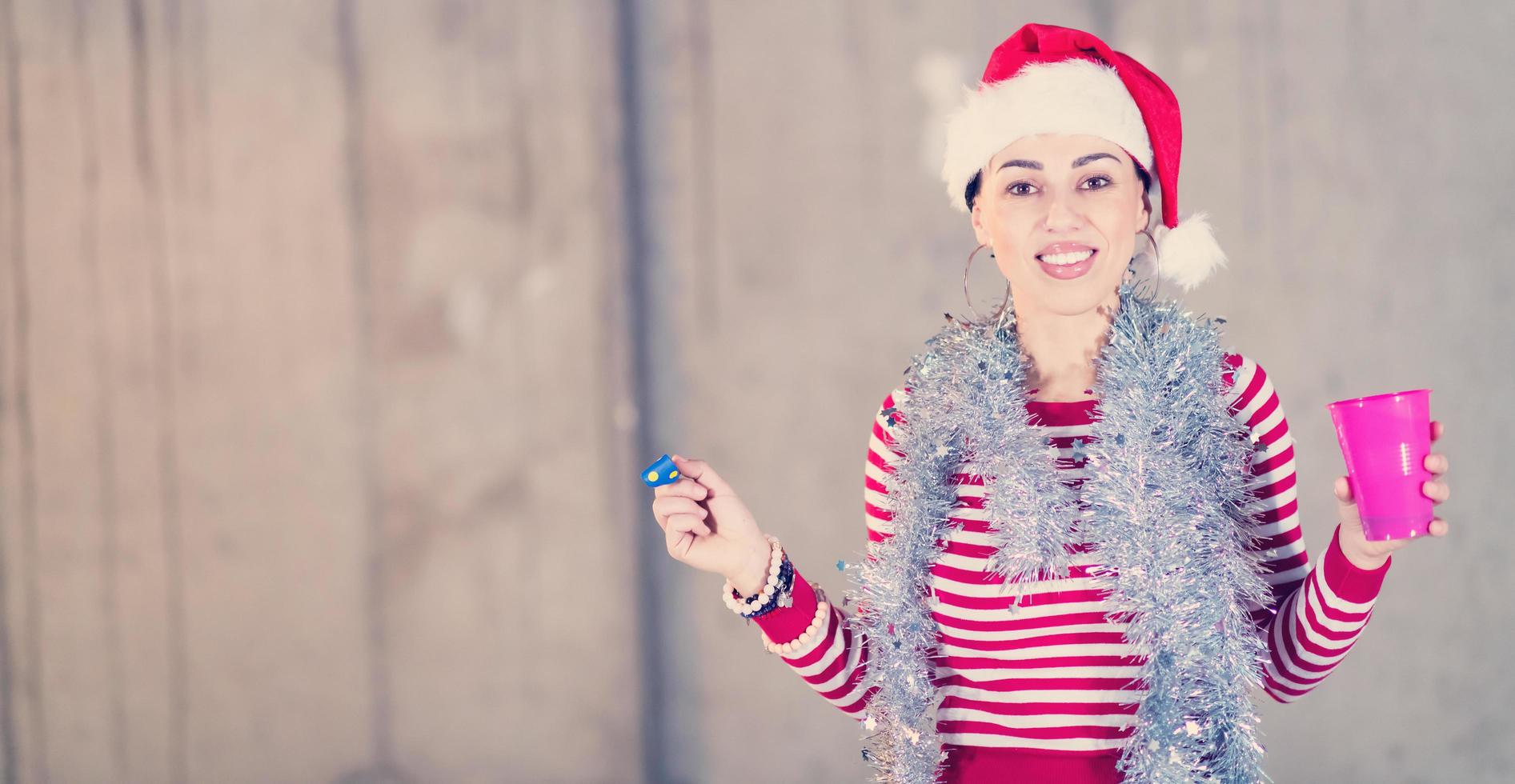 young business woman wearing a red hat and blowing party whistle photo