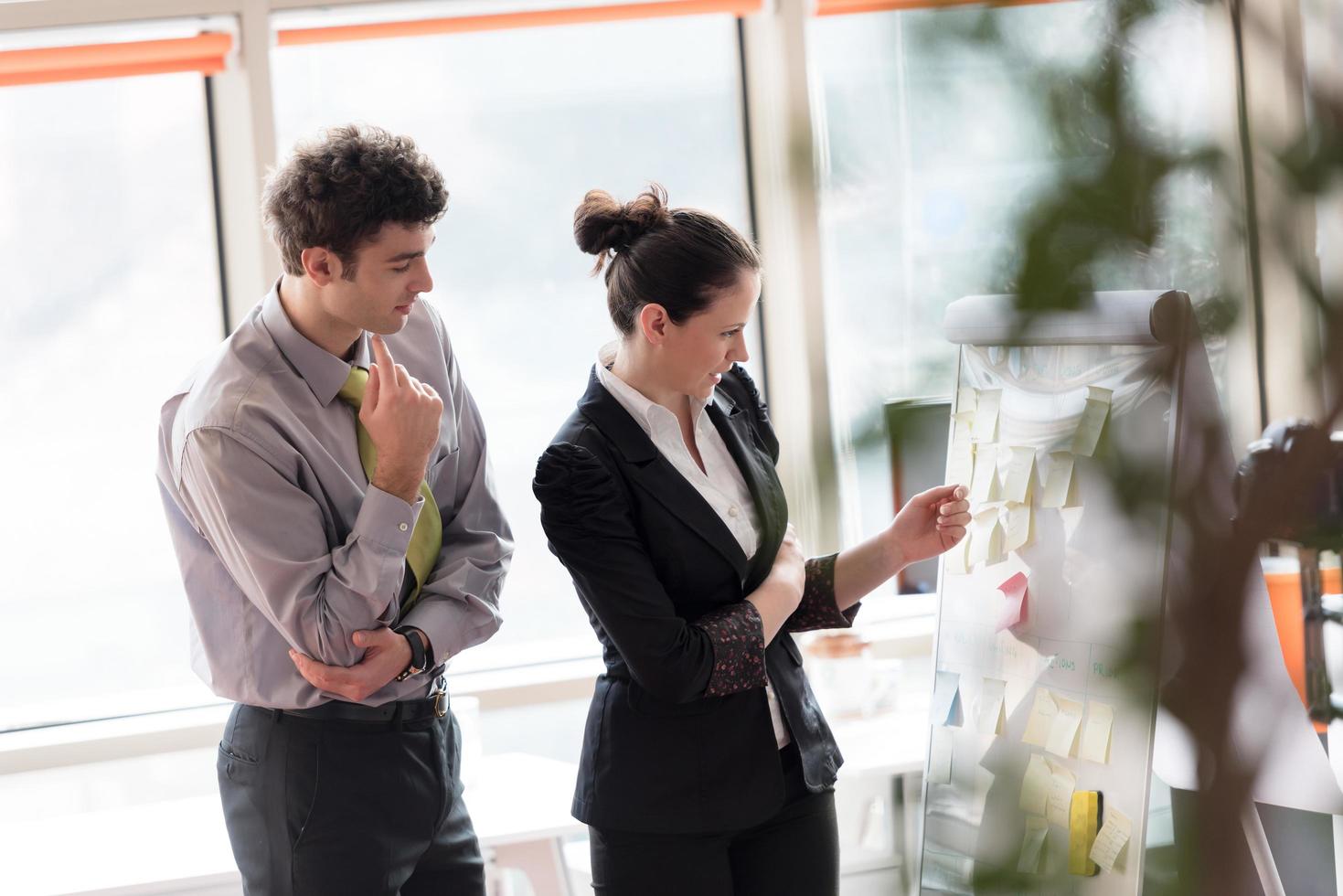 young couple working on flip board at office photo