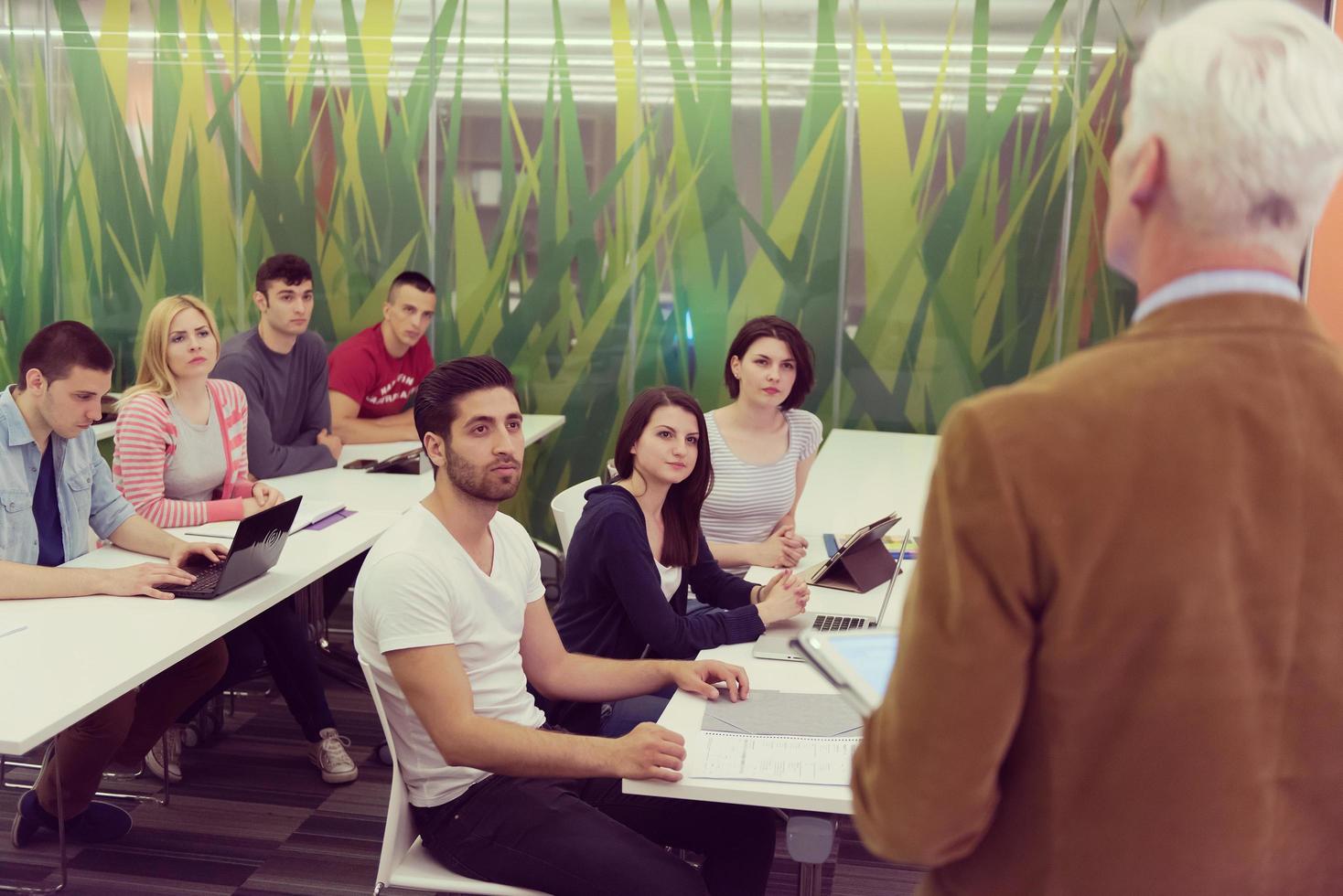 teacher with a group of students in classroom photo