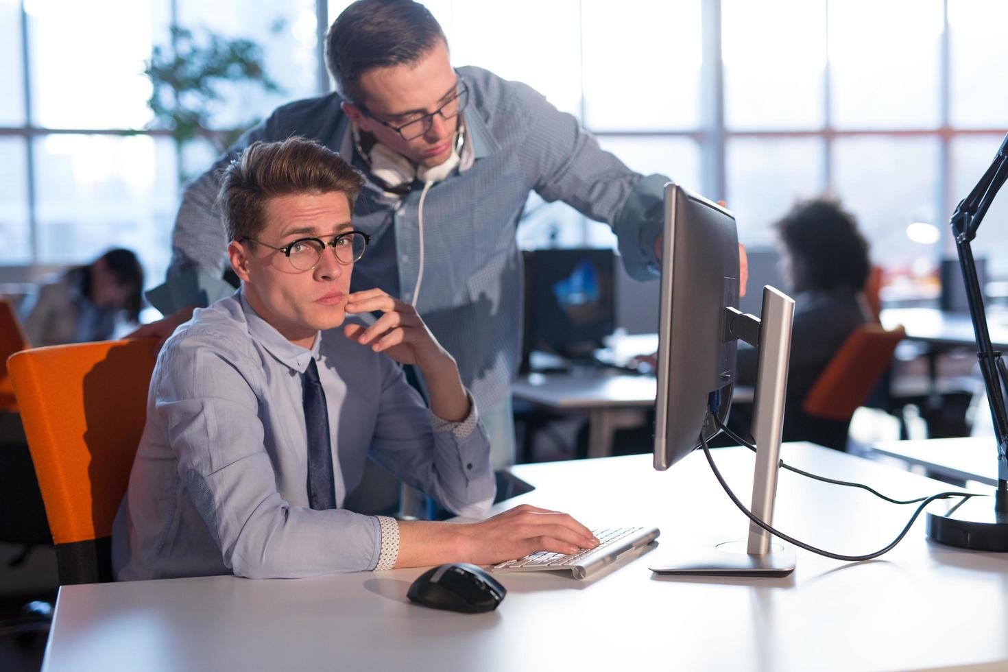 Two Business People Working With computer in office photo