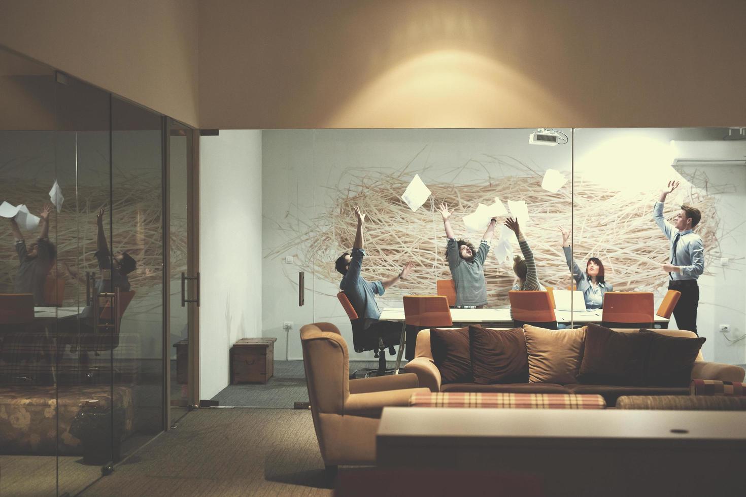 Group of young business people throwing documents photo