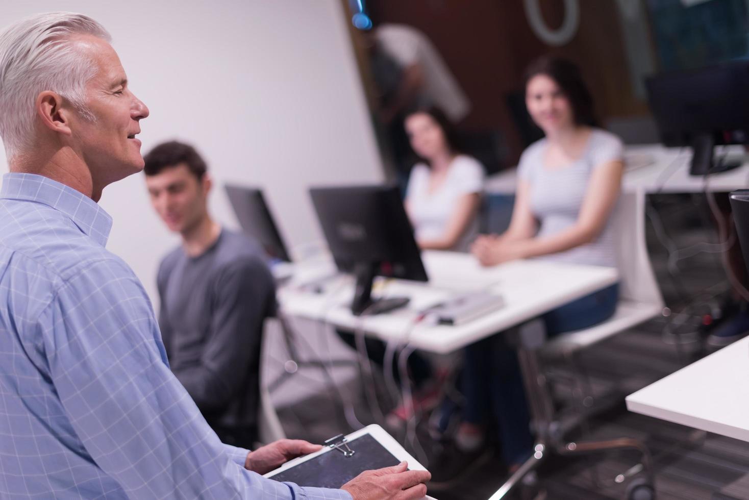 teacher and students in computer lab classroom photo