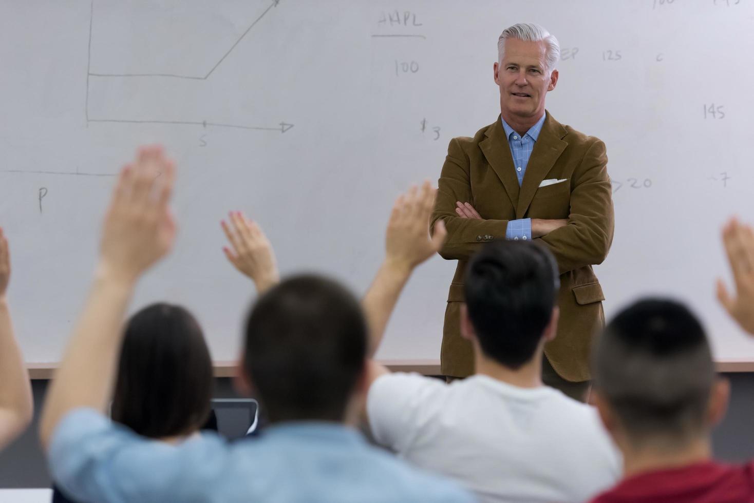 teacher with a group of students in classroom photo