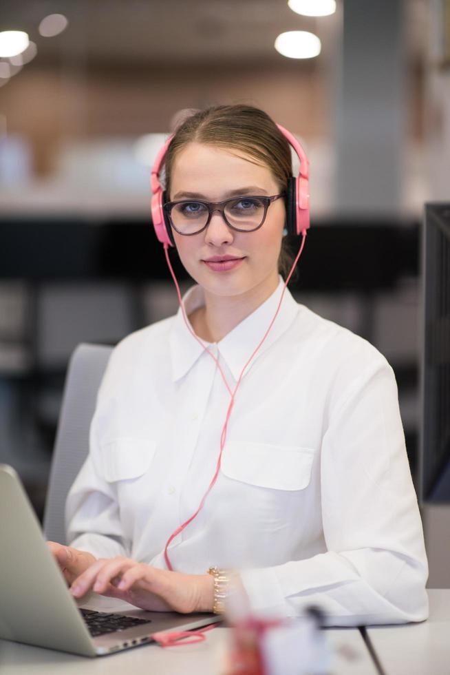 businesswoman using a laptop in startup office photo
