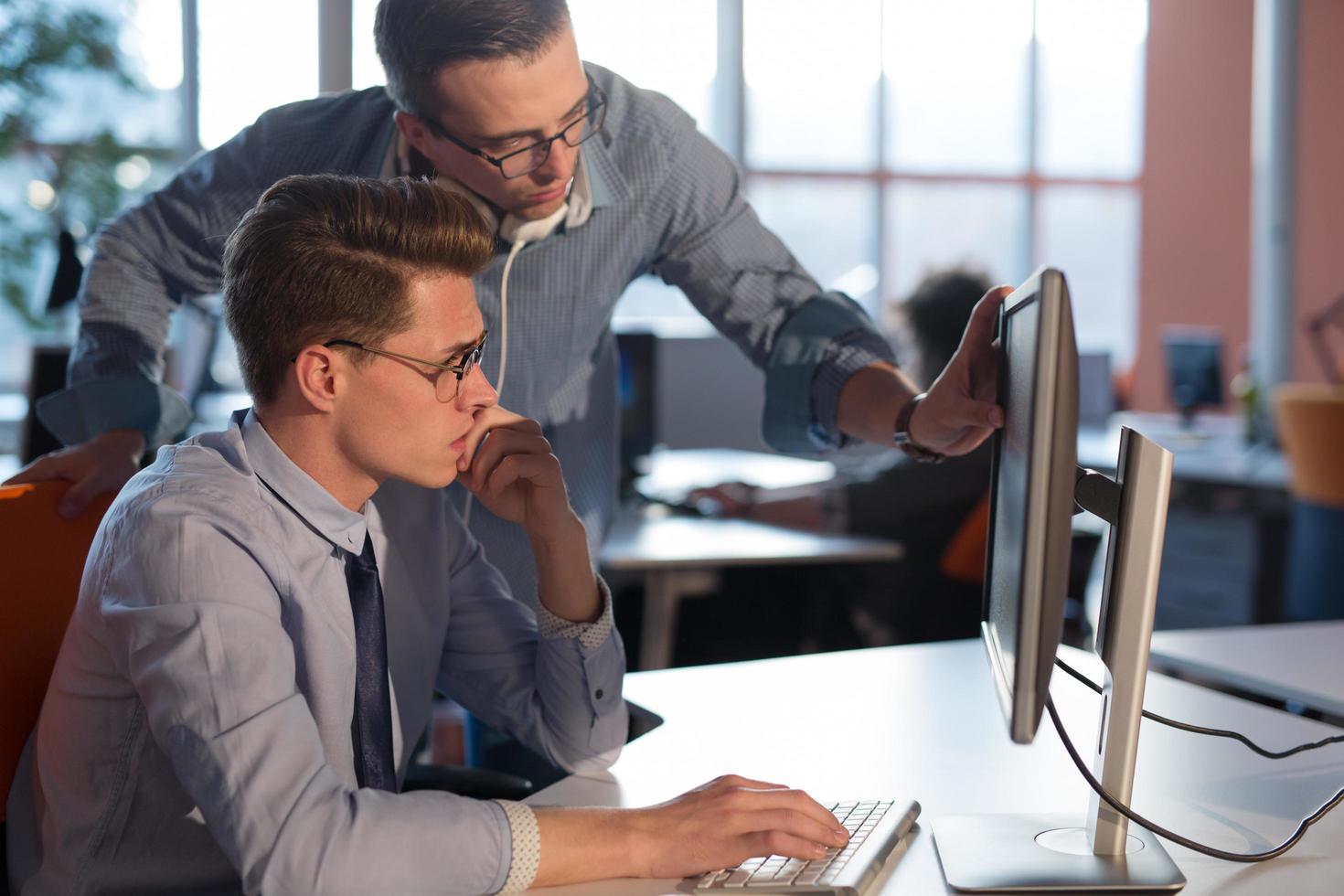 Two Business People Working With computer in office photo
