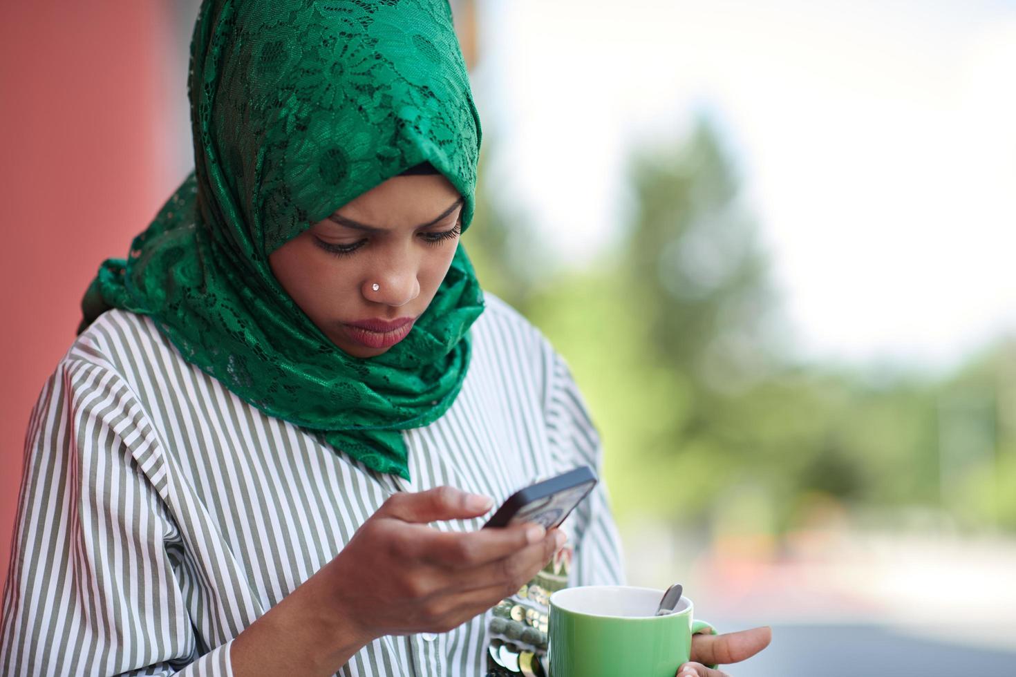 african muslim businesswoman using mobile phone photo
