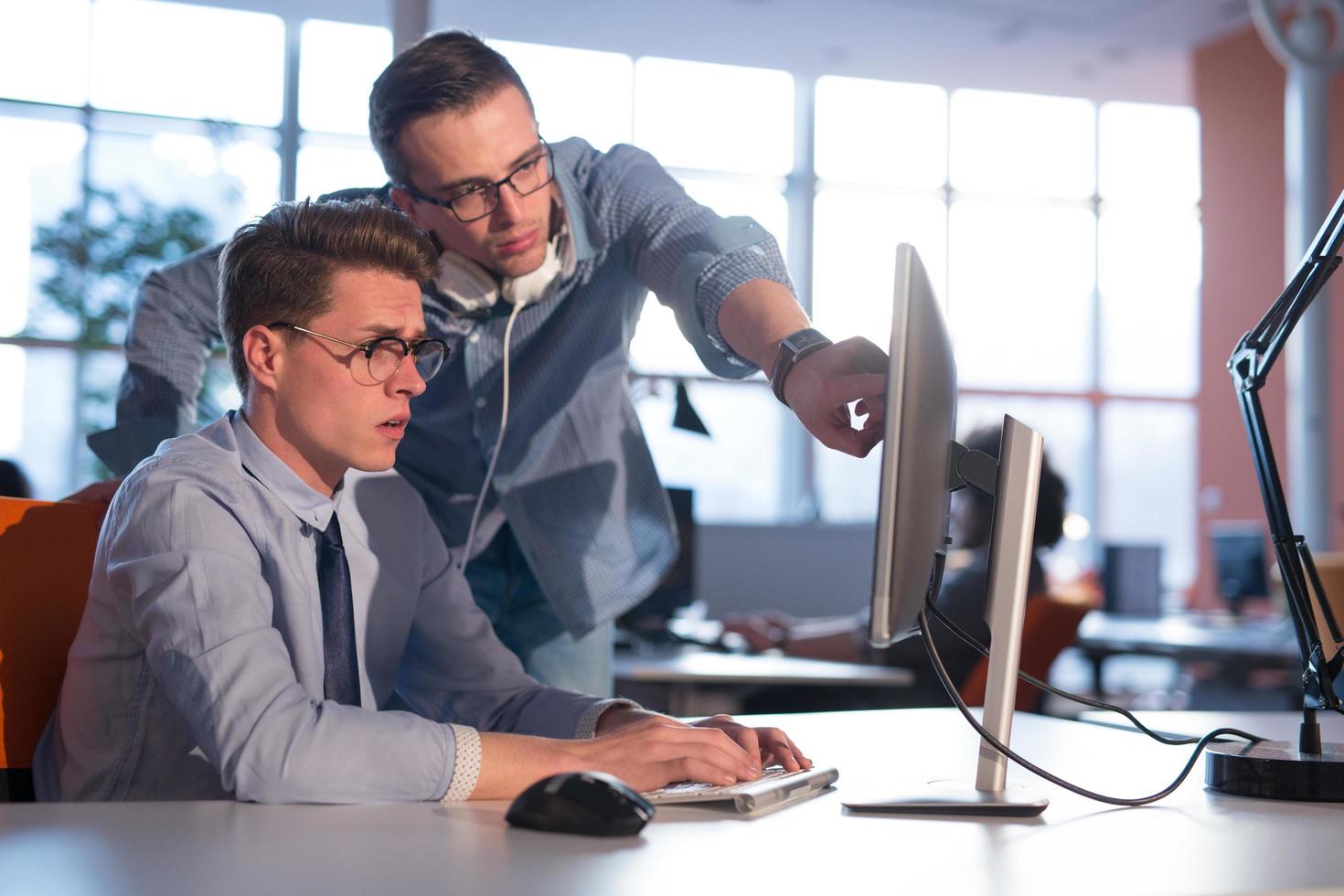 Two Business People Working With computer in office photo