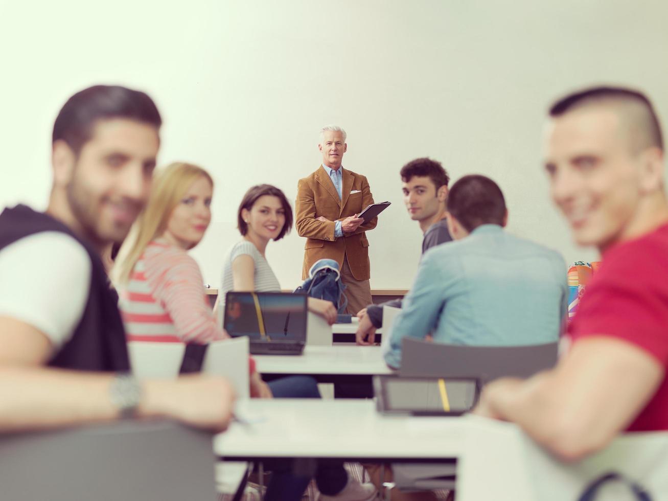 teacher with a group of students in classroom photo