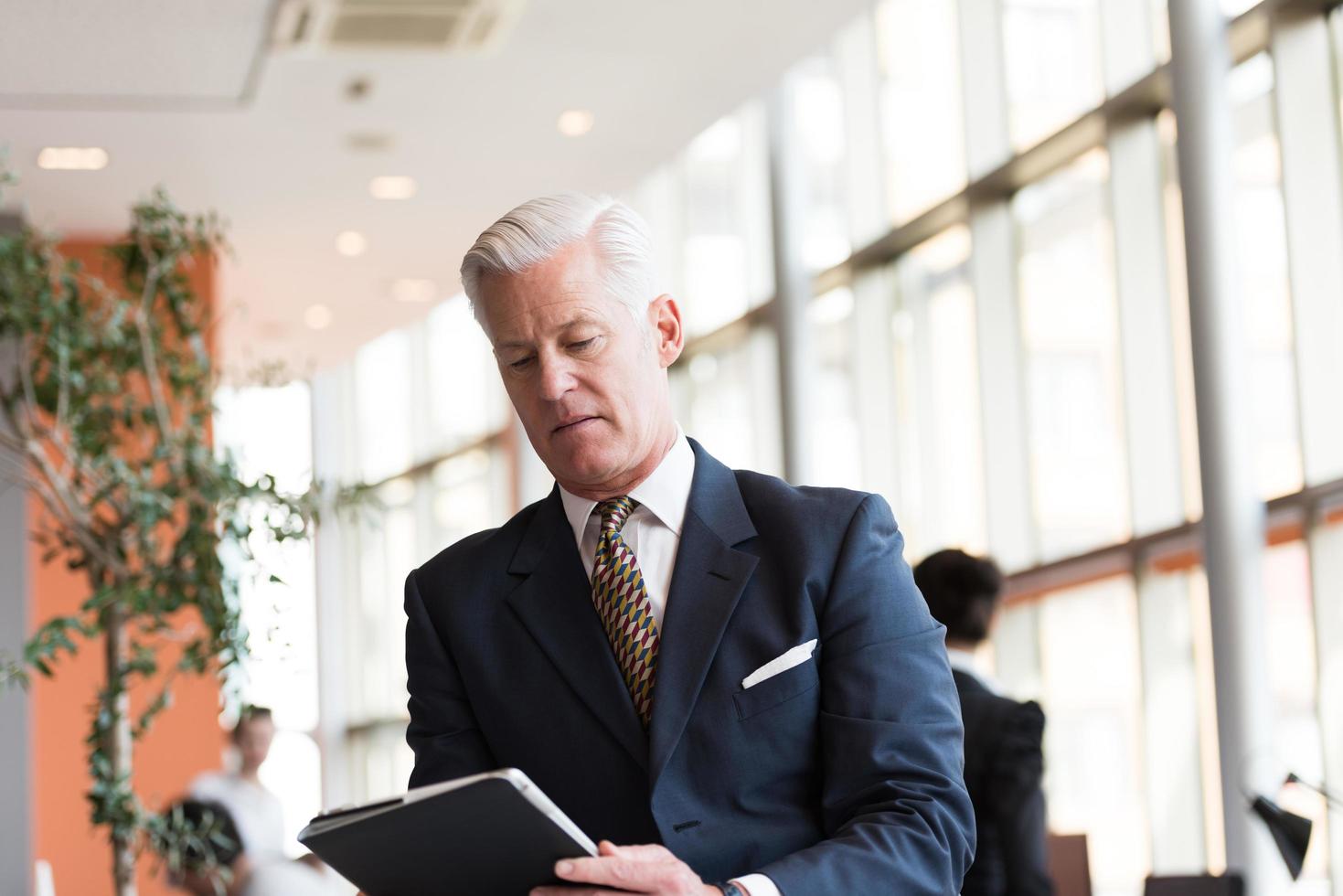senior business man working on tablet computer photo