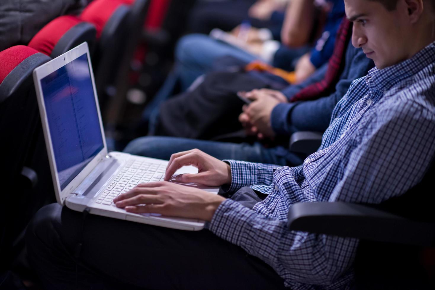 businessman using laptop computer during seminar photo