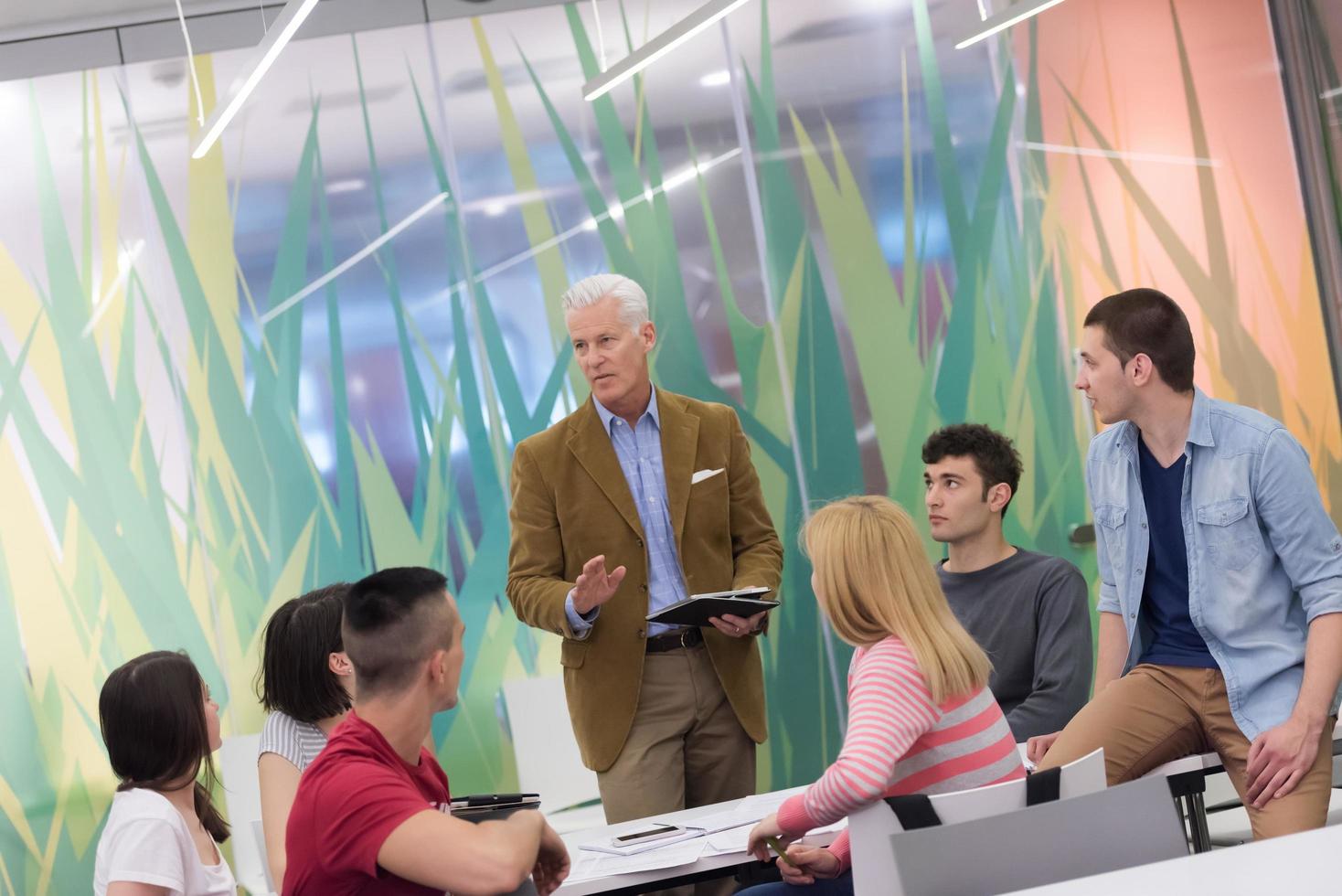 teacher with a group of students in classroom photo