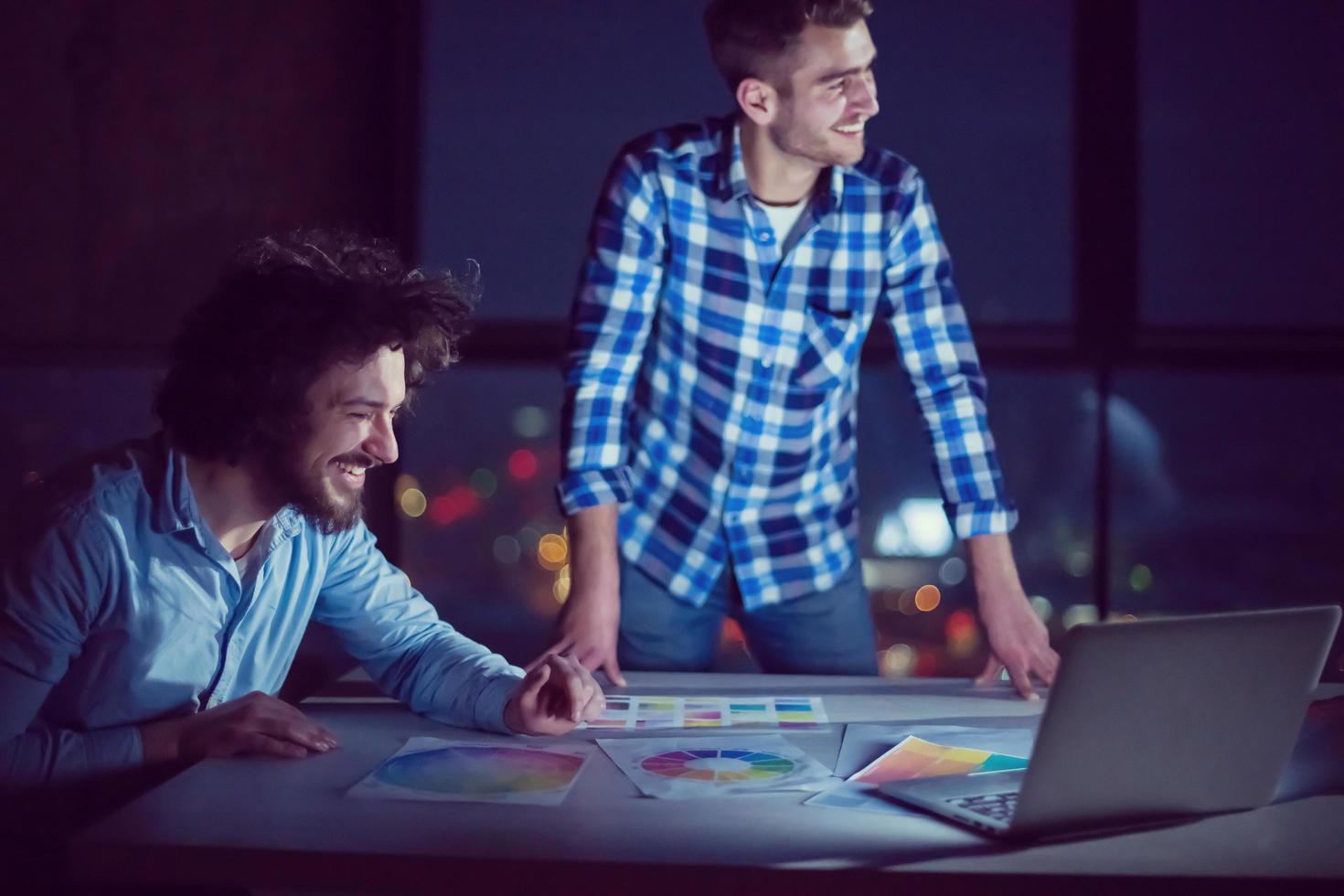 business people on construction site  in new startup office at night photo
